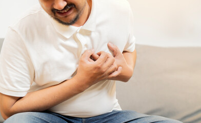 Cropped shot of adut man holding his chest and feeling pain suffering from heart attack