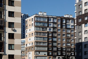 Cityscape on a sunny day. Modern building against the blue sky.