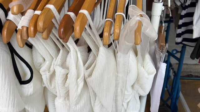 Thailand Bangkok 04.05.2025 Chatuchak market beautiful white dresses on hangers in the store to choose from