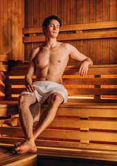 Young handsome man relaxing at the spa resort - Vertical photo