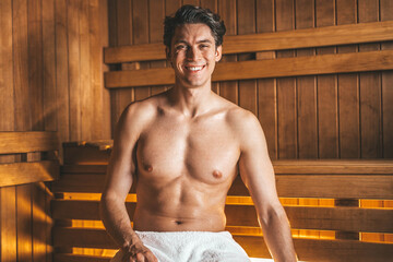 Young handsome man smiling at camera relaxing at the spa resort
