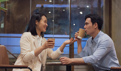 Couple enjoying coffee together in a cozy cafe in Hanoi, Vietnam during a warm afternoon