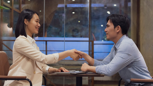 Business meeting between a man and woman in a modern cafe in Hanoi, Vietnam