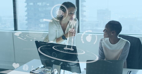 Collaborating two researchers studying anatomy in office with stylus and holographic display