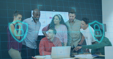 Collaborating seven coworkers leaning over laptops in conference room, with security overlay