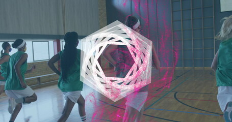 Running basketball team in green jerseys, white shorts doing drills on hall floor, pink overlay