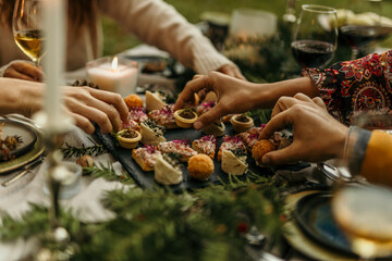 Friends sharing delicious appetizers at a festive dinner table