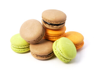 Pile of macaron cookies in various flavours and colours isolated on white background.