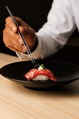 A hyper-realistic photo of wagyu beef nigiri on a black ceramic plate. The sushi consists of marbled raw wagyu beef draped over seasoned sushi rice, topped with a small dollop of white cream
