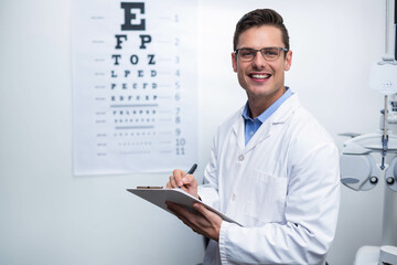 Optometry workstation featuring phoropter and Snellen chart in bright vision testing room