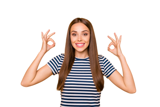 Portrait of cute pretty millennial in striped t-shirt showing ok sign advertising isolated over yellow background