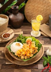 Rings of squid with vegetable, rice, chilli sauce, and lemon ice on a wood traditional table. Top view 