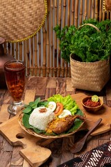 
Madura Ireng Seasoned Fried Chicken Rice or Madura Duck Rice with savory black spices and spicy chili sauce. Cuisine from Madura, East Java. Indonesian Food