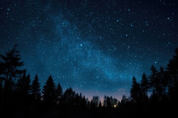 Fototapeta premium Silhouetted pine trees stand against a vibrant night sky, showcasing a breathtaking Milky Way galaxy and countless stars