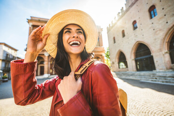 Happy female tourist enjoying summer vacation walking in city street - Delightful young woman laughing outside - Summertime holidays and tourism life style concept