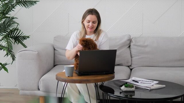 Woman with dog in arms communicates with family another country via video radiating happiness. Pet spins sharing happiness from communicating with loved. Ability see loved ones brings true happiness.