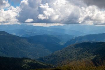 Fototapeta premium Fantastic scene of green meadows and forested mountain ranges in sunny weather. Location place Carpathians, Ukraine, Europe. Ecologically clean area. Photo wallpapers. Discovery the beauty of earth.