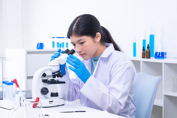 Teen girl adjusting microscope during laboratory experiment. Science, laboratory, scientist,...