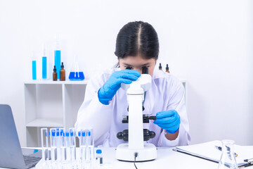 Teen girl adjusting microscope during laboratory experiment. Science, laboratory, scientist,...