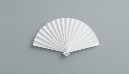 White paper fan on gray surface