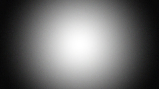 Black and white radial border vignette abstract background. Smooth gradient blend. Central light glow. Soft, blurred edges. Noise grain texture. Grayscale fade. Minimal monochrome light burst effect
