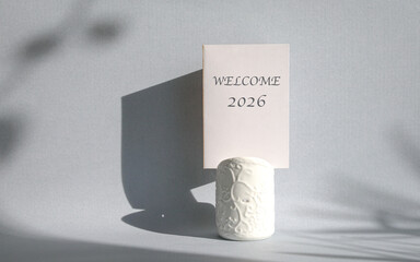 Welcome 2026 on a white card on top of a container.