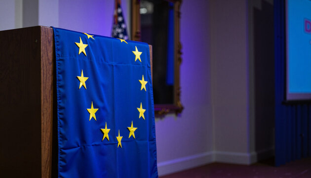 European Union flag draped on a podium in a room, with copy space