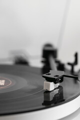 Close-up of a vinyl record playing on a modern turntable. Stylish and minimalistic.