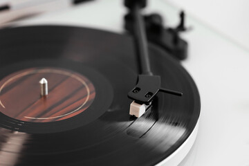 Close-up of a vinyl record playing on a modern turntable. Stylish and minimalistic.