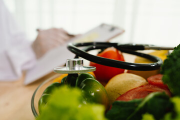 A gloved hand, resembling a doctor's, holds a tomato while using a stethoscope, symbolizing food...
