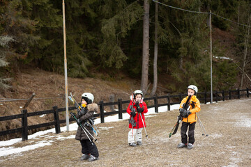 Enthusiastic children eagerly gear up for their much anticipated first skiing adventure in a...