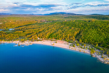 Aerial view of Buško lake in Bosnia and Herzegovina. Artificial lake with some motorhomes or campervans free camping on the beach.
