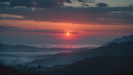 Obraz premium A unique view of a sunset over mountains and sea during dusk.