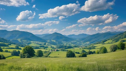 Summer Calm In Mountain with idyllic summer landscape of beautiful countryside, blue sky with clouds, grassy field, rolling hills, rural scenery, and empty copy space for text