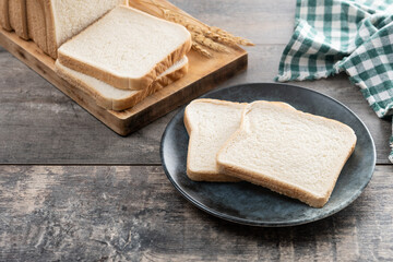 Slices of White Bread on wooden table