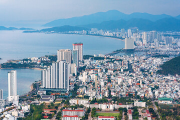 Panorama of Nha Trang city in Vietnam aerial view. Skyscrapers by sea in resort town in Asia above of drone