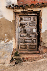 Old wooden door of derelict house in Spain
