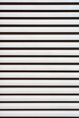 Obraz premium A close-up of a metal shutter with horizontal stripes