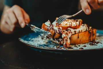 Eating chocolate orange cheesecake topped French toast.