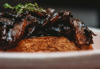 Sourdough topped with mushroom and port, close up.