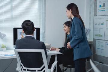 Asian businesspeople engaged in a meeting, discussing and analyzing financial charts that depict the company's profits and losses, all within a modern office environment