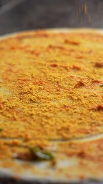 Karam Powder being added to a authentic South Indian Dosa