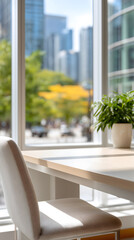 Obraz premium Modern office interior with a light wooden table and chairs near a large window overlooking a cityscape. Sunlight streams through the window, illuminating the room.