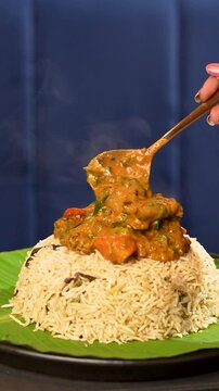 Mutton Dalcha being added on top of Bagara Rice - Authentic Hyderabadi Rice and Meat Combo Food