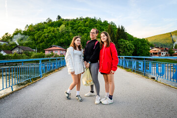 Family taking a picture on Kulen Vakuf bridge in Bosnia. Family visiting a famous bridge over the Una river to enter the small town of Kulen Vakuf in Bosnia.