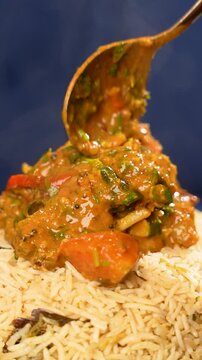 Mutton Dalcha being added on top of Bagara Rice - Authentic Hyderabadi Rice and Meat Combo Food