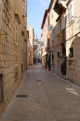 Picturesque Mediterranean street in coastal town Makarska, Croatia. Makarska is popular summer travel destination.