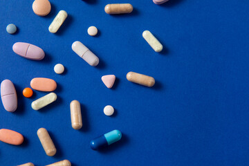 pills spill on blue background