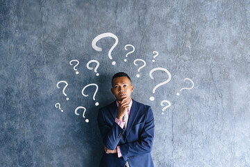 A black male businessman worried in a dark room