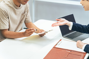 A black man and a Japanese female staff member having an interview